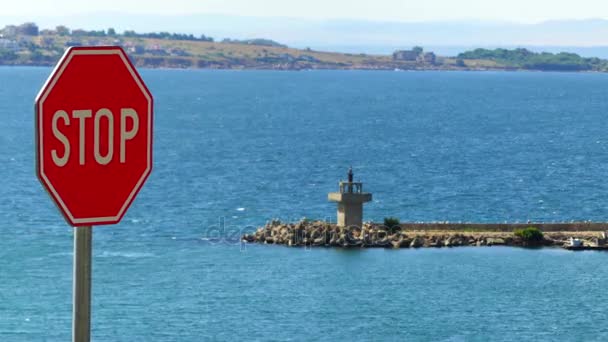 Red stop sign Stop on background of Black Sea coast. — Stock Video