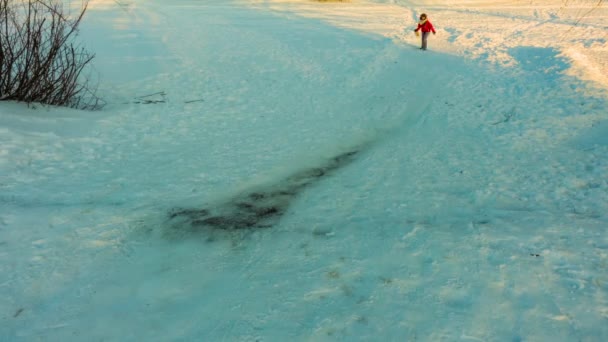 Timelapse: Little beautiful girl comes down from snow-capped hill and laughs against backdrop of winter nature — Stock Video