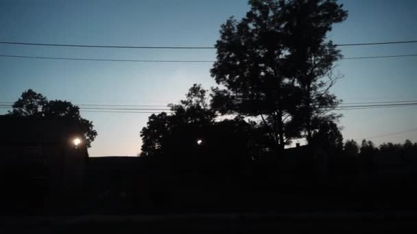 Slow motion mot bakgrund av solnedgång i byn. — Stockvideo