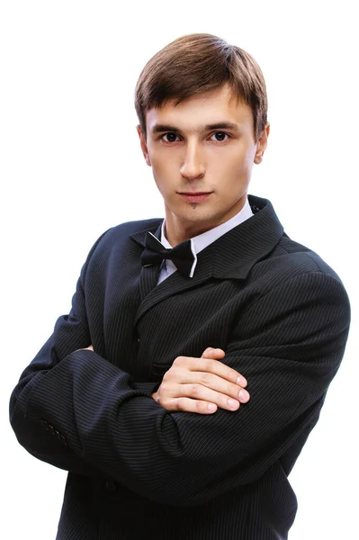 Jovem em um terno preto, camisa branca e borboleta gravata — Fotografia de Stock