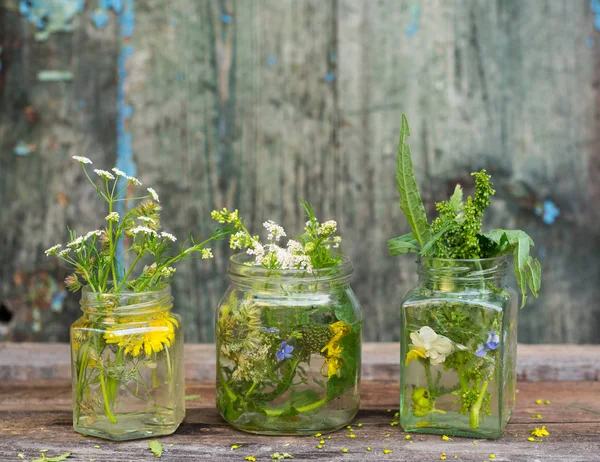 Bouquet of wild summer flowers in a glass jar — Stock Photo, Image