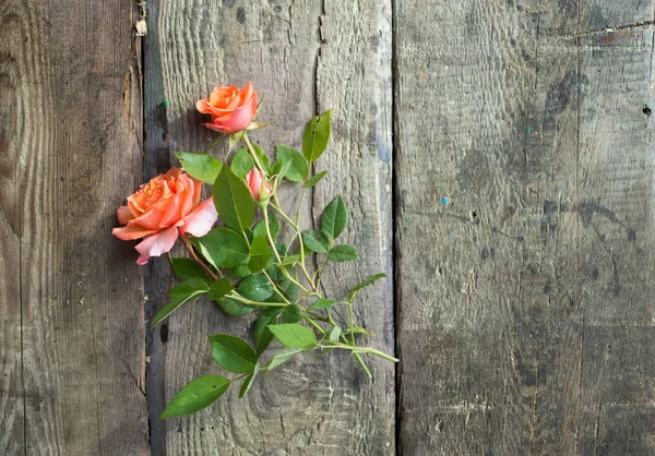 Rosa blommor i craft papper kuvert över trä bakgrund — Stockfoto