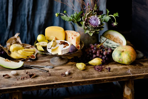 Dark still life with different cheese — Stock Photo, Image