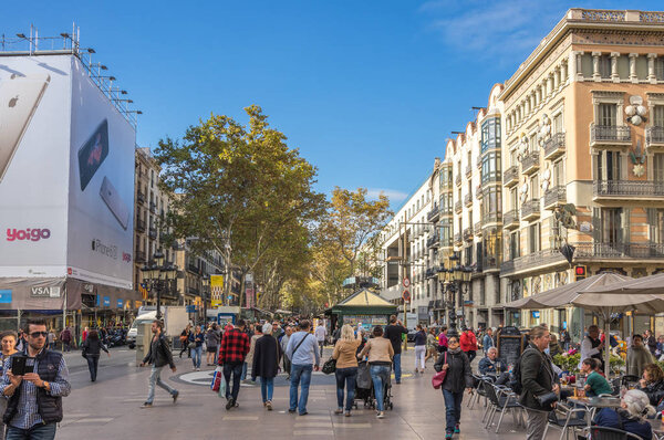 BARCELONA, SPAIN - OCTOBER 22, 2015: La Rambla is a pedestrian street in central Barcelona, popular with tourists and locals alike, Spain