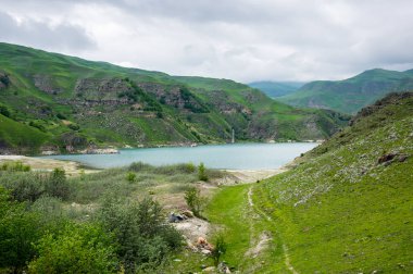 Bylym lake in the Caucasus mountains in Russia clipart