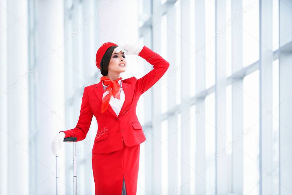 Young stewardess indoors