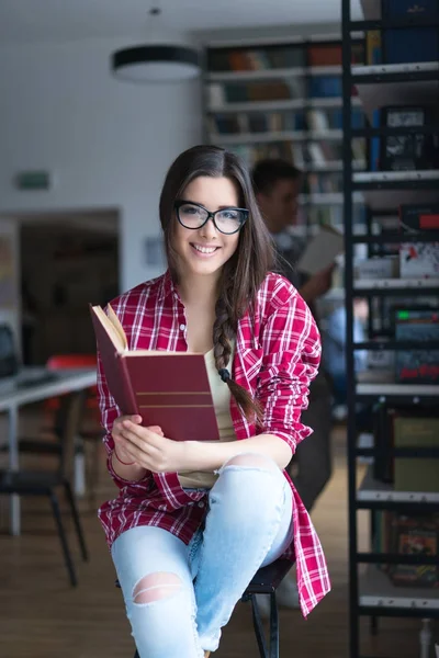 Chica feliz en la biblioteca — Foto de Stock