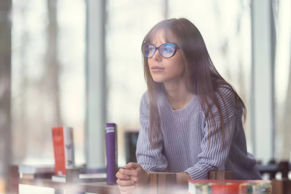 Young student in the library — Stock Photo, Image