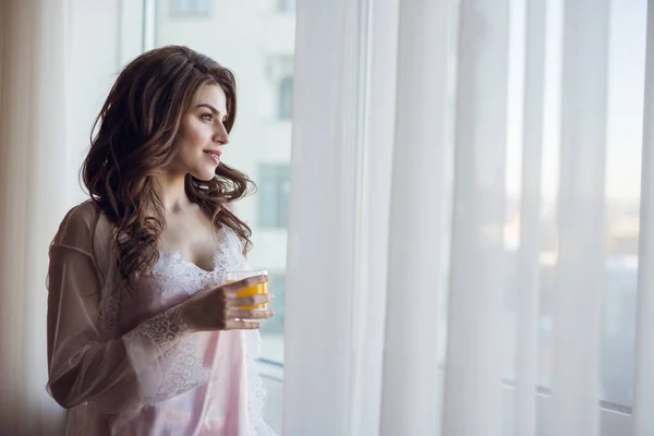 Attractive bride at the window — Stock Photo, Image