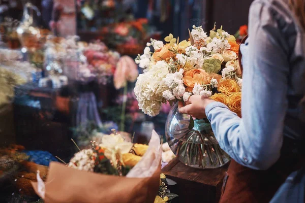 Young florist with flowers — Stock Photo, Image