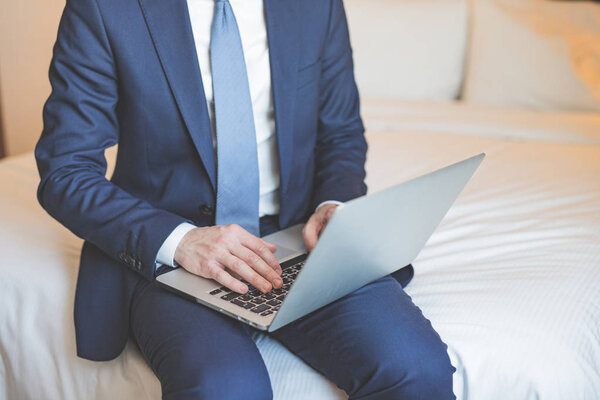 Young businessman with laptop closeup