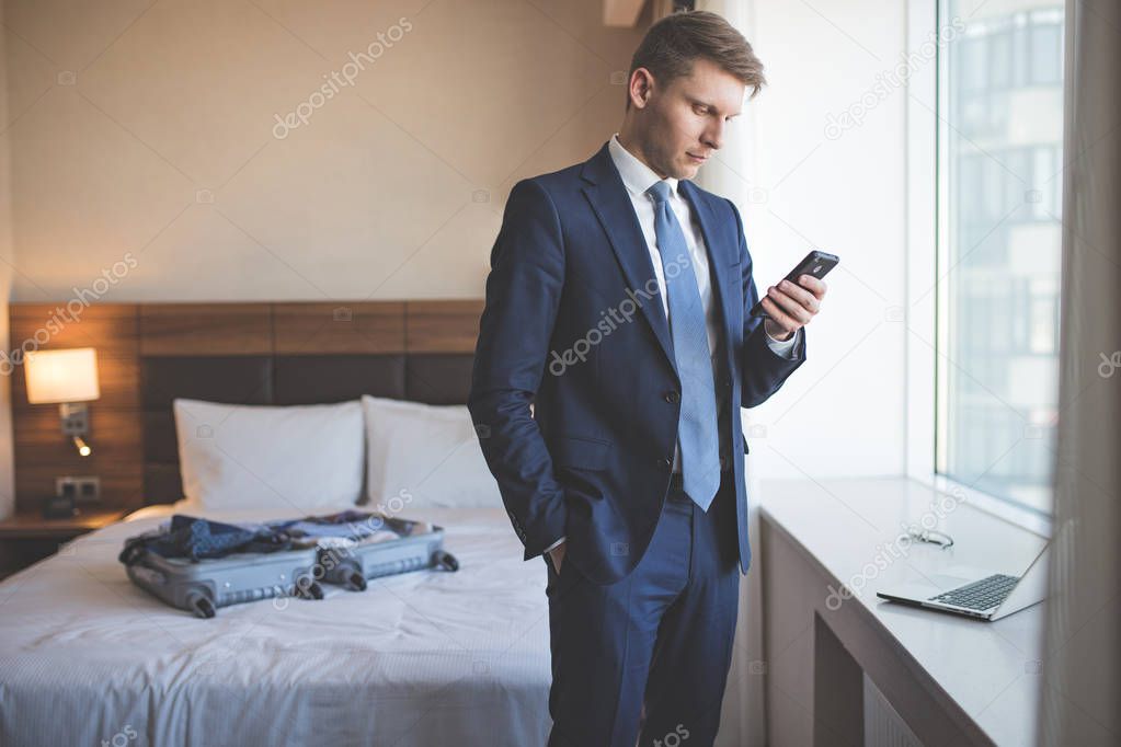 Young businessman in a suit indoors