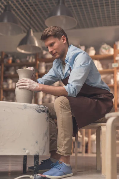 Young man in apron — Stock Photo, Image