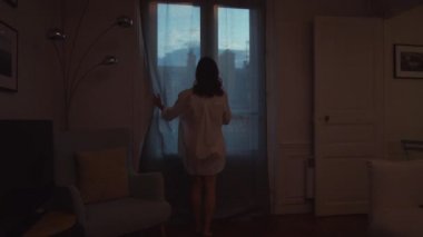Young girl opening a balcony with a view 