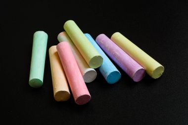 Siyah arkaplanda renkli boya kalemleri