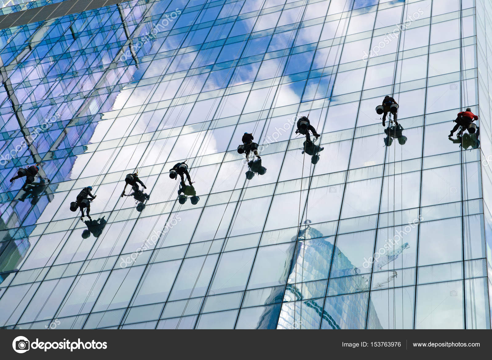 Workers Cleaning Windows And Walls Of Skyser Stock