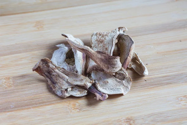 Dried porcini mushrooms on a wooden table. Food background. — Stock Photo, Image