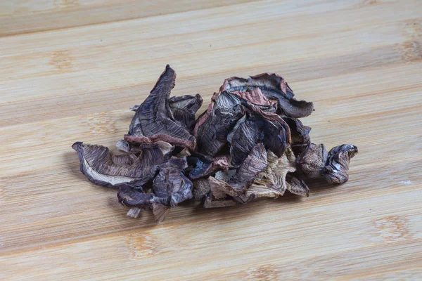 Dried porcini mushrooms on a wooden table. Food background. — Stock Photo, Image