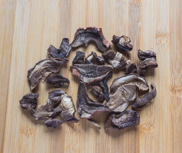 Dried porcini mushrooms on a wooden table. Food background. — Stock Photo, Image