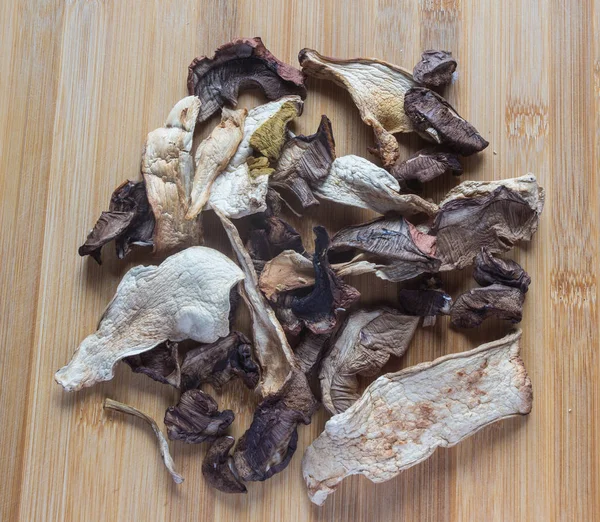 Dried porcini mushrooms on a wooden table. Food background. — Stock Photo, Image