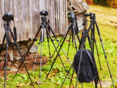 lot of tripods without cameras are waiting for the shooting clipart
