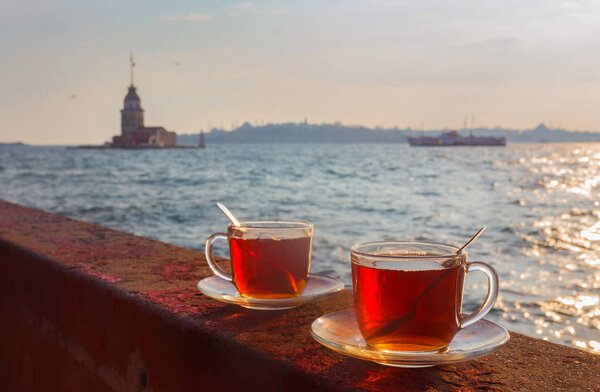 A cup of Turkish tea on the background of the Maiden Tower