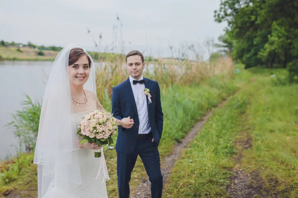 新郎と新婦の公園で 結婚式のドレス ブライダル結婚式の花の花束 — ストック写真