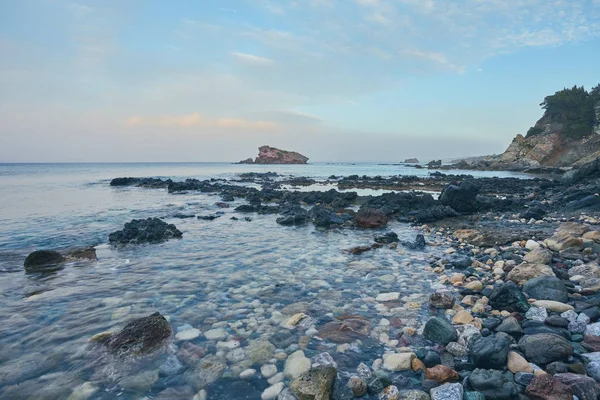 Pierres et rochers à l'avant-garde avec surf crémeux reflux et coulant sur la plage de Polis, Chypre . — Photo