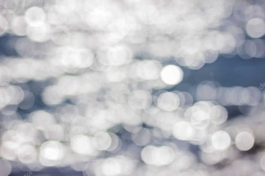 Beautiful blurred blue and white abstract water background with bokeh.