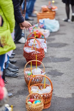 Easter holiday, baskets near the church. clipart