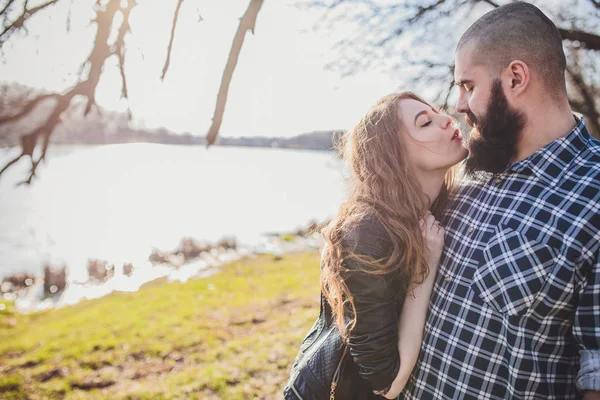 A girl and a guy are walking in the park. Portrait of a couple, a love story.Happy smiling, loving couple together outstretched at beautiful nature. — 스톡 사진