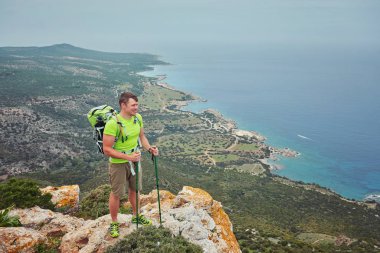 Dağın tepesindeki turist, körfeze bakan deniz manzaralı..