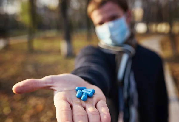 Guy Medical Mask Holds Out His Hands Pills Camera Concept — Stock Photo, Image