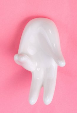 Pembe arka planda el şekli olan seramik standı