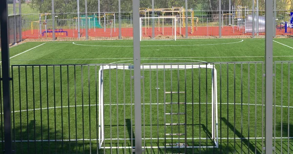 Football field near fence at day sunny day — Stock Photo, Image