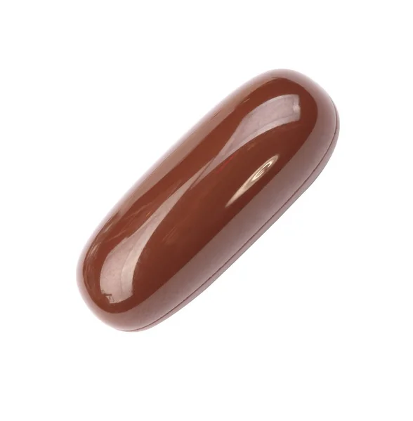 Uma pílula de gelatina marrom isolada em backgroung branco — Fotografia de Stock