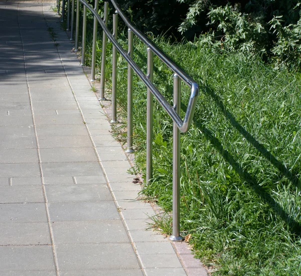 Metal fence in park at dry sunny summer day — Stock Photo, Image