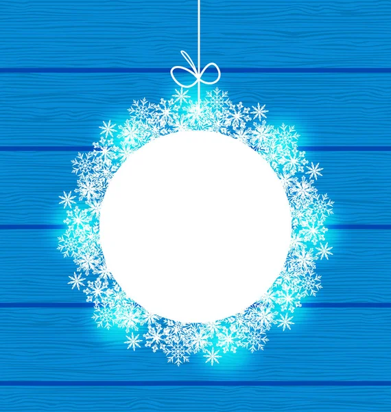 Різдвяна кругла рамка, зроблена в сніжинках на синьому дерев'яному фоні — стокове фото