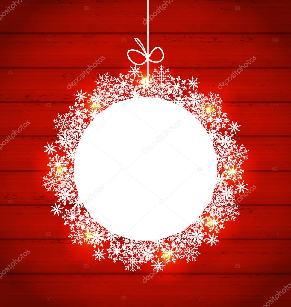 Christmas round frame made in snowflakes on red wooden backgroun