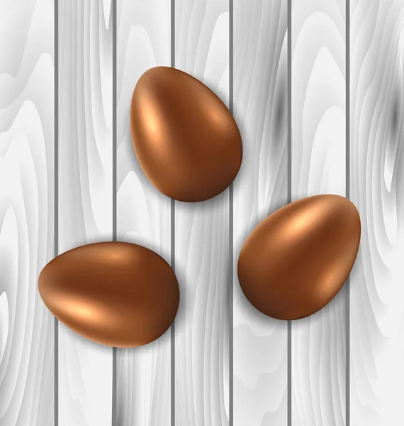 Chocolate de Páscoa três ovos em fundo de madeira cinza — Fotografia de Stock