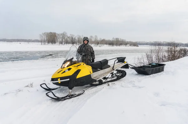 Pescador em uma moto de neve — Fotografia de Stock