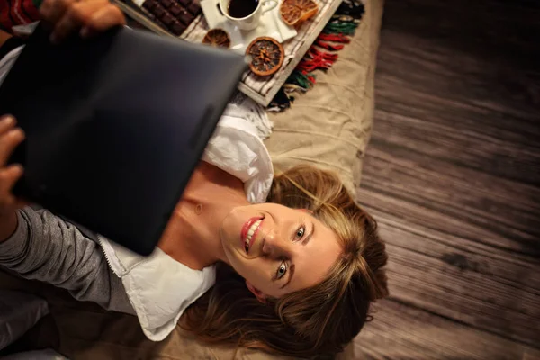 Joyful woman watching a movie on a tablet — Stock Photo, Image