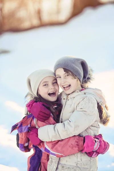 Two young girls laughing on a winter day — Stock Photo, Image