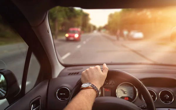 Sunny day behind the steering wheel of the car — Stock Photo, Image