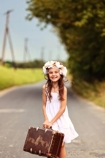 Happy young girl in a wreath dancing on the road — Stock Photo, Image