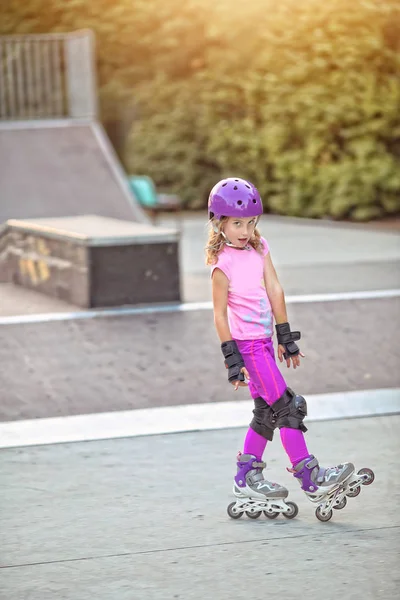 Young girl practicing roller skating on the skatepark Stock Picture