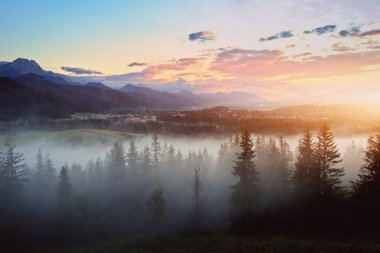 misty sunset over the mountains clipart