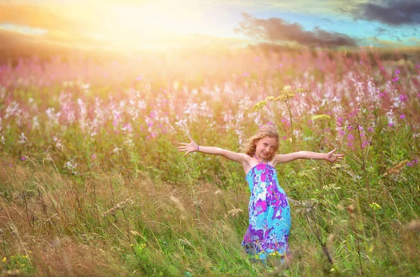 花のフィールドにうれしそうな踊っている女の子 — ストック写真