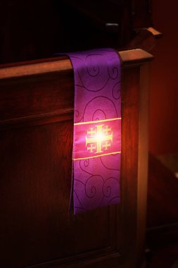 glow of the stole and the cross in the church clipart