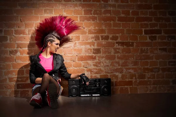 Punk girl on brick wall background — Stock Photo, Image